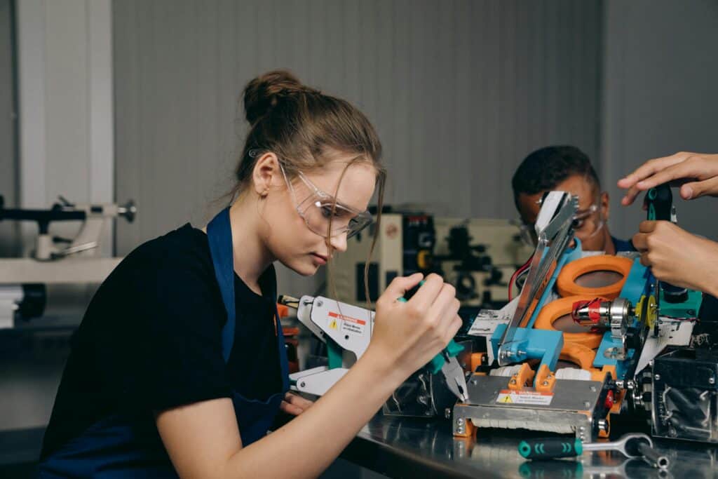 Young Woman in a Black Shirt Holding Pliers