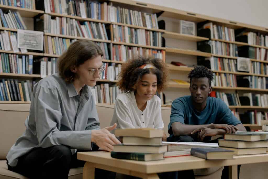 A group of high school students reading books in a library.